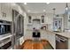 Modern kitchen with stainless steel appliances, white cabinets, and hardwood floors at 9334 Seascape Dr, Indianapolis, IN 46256