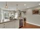 Modern kitchen with stainless steel appliances, white cabinets, and hardwood floors with eating area at 9334 Seascape Dr, Indianapolis, IN 46256