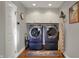 Well-organized laundry room featuring modern washer/dryer, storage cabinets, and practical accessories for efficient chores at 9334 Seascape Dr, Indianapolis, IN 46256
