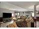 Cozy living room with a large sectional sofa, a TV, and access to the outdoors at 9334 Seascape Dr, Indianapolis, IN 46256