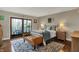 Comfortable main bedroom with a decorative rug, bench and walkout access to a balcony at 9334 Seascape Dr, Indianapolis, IN 46256