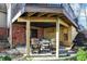 Covered outdoor seating under the deck provides a cozy spot for relaxation or socializing, with views of the brick foundation at 9334 Seascape Dr, Indianapolis, IN 46256