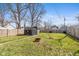 Spacious backyard with a fire pit, a hammock, a shed, and a wood fence at 935 N Tacoma Ave, Indianapolis, IN 46201