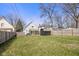 Backyard features a large grassy space with a shed, a wood fence, and mature trees at 935 N Tacoma Ave, Indianapolis, IN 46201