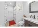 Bright, clean bathroom featuring a modern vanity, toilet, and shower with black hardware at 935 N Tacoma Ave, Indianapolis, IN 46201