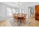 Well-lit dining room with hardwood floors, seating for six, and views of the living space at 935 N Tacoma Ave, Indianapolis, IN 46201