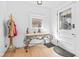 Bright entryway with light wood floors, decorative table, and coat rack at 935 N Tacoma Ave, Indianapolis, IN 46201