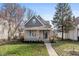 Charming gray two-story home with manicured lawn and covered front porch at 935 N Tacoma Ave, Indianapolis, IN 46201