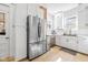Bright kitchen featuring stainless steel refrigerator, white cabinets, and modern appliances at 935 N Tacoma Ave, Indianapolis, IN 46201