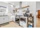 Modern white kitchen featuring sleek appliances, ample counter space, and open shelving at 935 N Tacoma Ave, Indianapolis, IN 46201