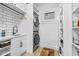 Well-organized laundry room with modern appliances, ample storage, sink, and shelving, flooded with natural light at 935 N Tacoma Ave, Indianapolis, IN 46201