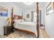 Serene bedroom featuring a four-poster bed, plush linens, and soft natural light from dual windows at 935 N Tacoma Ave, Indianapolis, IN 46201