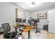 Functional home office featuring a height-adjustable desk, task chair, and ample natural light at 935 N Tacoma Ave, Indianapolis, IN 46201