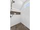 Modern shower features sleek white hexagonal tiles, dark grout, built-in shelves and dark stone flooring at 935 N Tacoma Ave, Indianapolis, IN 46201