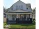 Charming two-story home with a covered front porch, perfect for enjoying the outdoors at 950 N Rural St, Indianapolis, IN 46201