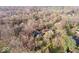 A beautiful aerial view of the home with mature trees and landscaping at 98 Highland Manor S Ct, Indianapolis, IN 46228