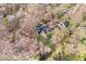A beautiful aerial view of the home with mature trees and landscaping at 98 Highland Manor S Ct, Indianapolis, IN 46228