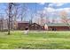 A backyard view of the house, showcasing the siding and yard at 98 Highland Manor S Ct, Indianapolis, IN 46228