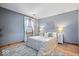 Relaxing bedroom with a queen bed, hardwood floors, and a bright window with sheer curtains at 98 Highland Manor S Ct, Indianapolis, IN 46228