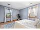 Serene bedroom with a queen bed, hardwood floors, and two bright windows with sheer curtains at 98 Highland Manor S Ct, Indianapolis, IN 46228