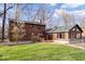 Charming log cabin-style home featuring a well-maintained lawn and natural surroundings at 98 Highland Manor S Ct, Indianapolis, IN 46228
