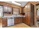 Rustic log cabin kitchen with wood cabinetry and stainless steel appliances at 98 Highland Manor S Ct, Indianapolis, IN 46228