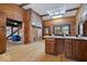 Log kitchen featuring skylight, light wood floor, and view to sitting room and staircase at 98 Highland Manor S Ct, Indianapolis, IN 46228