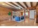 Cozy log cabin living room with exposed beams, fireplace, and comfortable seating at 98 Highland Manor S Ct, Indianapolis, IN 46228