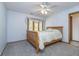 Bedroom features light-blue walls, a ceiling fan, and an exterior window at 1143 N Sugar Bend Run, Greenfield, IN 46140
