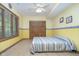 Cozy bedroom featuring wood-look floors, a double closet, and bright yellow walls at 1143 N Sugar Bend Run, Greenfield, IN 46140