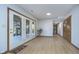 Bright hallway with French doors leading to a patio, ample closet space, and wood-look flooring at 1143 N Sugar Bend Run, Greenfield, IN 46140