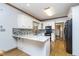 Modern kitchen featuring white cabinets, granite countertops, stainless steel appliances, and hardwood floors at 1143 N Sugar Bend Run, Greenfield, IN 46140