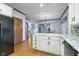 Updated kitchen with granite countertops, white cabinets, hardwood floors and stainless steel appliances at 1143 N Sugar Bend Run, Greenfield, IN 46140