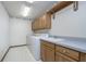 Functional laundry room features a washer, dryer, sink, cabinets, and ample storage space at 1143 N Sugar Bend Run, Greenfield, IN 46140