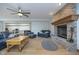 Spacious living room with a brick fireplace, ceiling fan, and ample seating area at 1143 N Sugar Bend Run, Greenfield, IN 46140