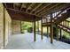 Covered patio with exposed ceiling beams, stairs and a brick accent wall at 1143 N Sugar Bend Run, Greenfield, IN 46140