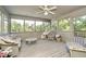 Cozy sunroom with wicker furniture, ceiling fan, and large windows offering scenic outdoor views at 1143 N Sugar Bend Run, Greenfield, IN 46140