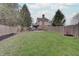 Large grassy backyard with wooden fence and mature trees providing plenty of shade at 1401 Shadow Ct, Zionsville, IN 46077