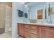 Well-lit bathroom features a double sink vanity with wood cabinets and a shower/tub combination with decorative curtain at 1401 Shadow Ct, Zionsville, IN 46077