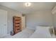 Cozy bedroom featuring neutral walls, carpet flooring, and a wooden shelf with wicker baskets for stylish storage at 1401 Shadow Ct, Zionsville, IN 46077