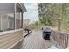 Outdoor wooden deck featuring an open view of the backyard and surrounding area, enhanced by a grill and cozy seating at 1401 Shadow Ct, Zionsville, IN 46077