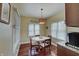 Bright breakfast nook featuring a white table, wood chairs, and natural light from the surrounding windows at 1401 Shadow Ct, Zionsville, IN 46077