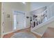 Bright foyer featuring hardwood floors, a staircase, and natural light, offering a warm welcome at 1401 Shadow Ct, Zionsville, IN 46077