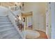 Grand foyer with a staircase, hardwood floors, and high ceilings, creating an elegant entrance at 1401 Shadow Ct, Zionsville, IN 46077
