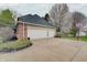Spacious three-car garage with a concrete driveway and basketball hoop, offering ample parking and storage at 1401 Shadow Ct, Zionsville, IN 46077