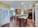 Open kitchen features wood cabinets, a center island with granite counters and seating at 1401 Shadow Ct, Zionsville, IN 46077