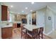 Bright kitchen with wood cabinets, granite counters, and a center island with seating at 1401 Shadow Ct, Zionsville, IN 46077