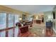 Open-concept living room with hardwood floors, french doors, and sightlines into the kitchen at 1401 Shadow Ct, Zionsville, IN 46077
