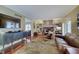 Open living room with hardwood floors, fireplace and comfortable seating, with a TV on the wall at 1401 Shadow Ct, Zionsville, IN 46077