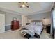 Bedroom featuring a tray ceiling, neutral walls, a queen bed, and side tables with reading lamps at 1401 Shadow Ct, Zionsville, IN 46077